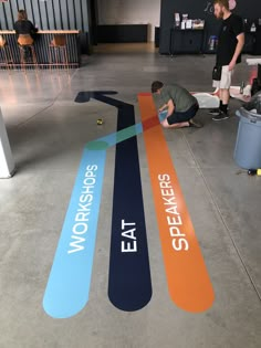 a man is working on a sign in an office