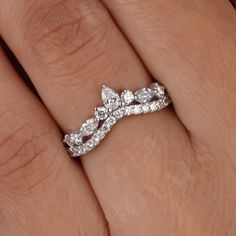 a woman's hand with a diamond ring on it