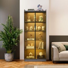 a living room filled with furniture and a tall glass case full of gold figurines