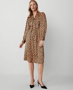 Unleash your wild side with the Ann Taylor Animal Print Tie Neck Midi Dress. This captivating piece is perfect for transitioning from day to night with its elegant animal print and flattering tie neck design. 

- Size: Regular - 2
- Color: Tan
- Material: 100% Polyester
- Gender: Female
- Fit: Hits below the knee
- Features: V-neck with ties, long sleeves with shirred sleeve caps and button cuffs, button front placket, front and back yoke with shirring below, hidden side zipper, lined body

Mach Fall Tie-neck Dress For Work, Taylor Animal, Shirred Sleeve, Weekend Sweater, Weekend Dresses, Tan Woman, Long Sleeve Dresses, Sleeve Dresses, Animal Print Dresses