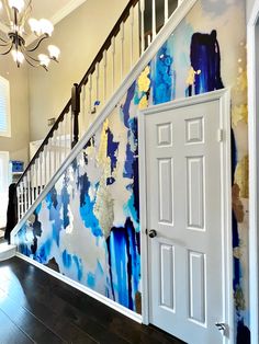 an open door leading to a hallway with blue and yellow paint on the wall behind it