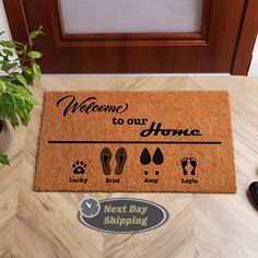 welcome to our home door mat with footprints and slippers on the floor next to it