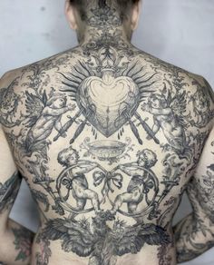 the back of a man with tattoos on his body and chest is covered in many different designs