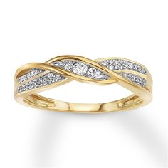 a yellow gold ring with white diamonds on the sides and a twist design in the middle