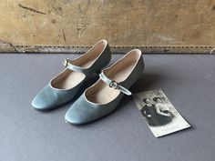 A pair of exquisite vintage party or evening shoes by master shoemaker Michel Vivien, handmade in Italy.  The Paris blue (or is it grey?) coloured silk is beautifully contrasted with the grey piping to the edges. The antiqued brass buckles give another 'heritage' feel and the dainty kitten heel is just enough to balance comfort with style. Michel Vivien evening shoes range in price from €700.00 to €1000.  * silk upper / lambskin insole and lining * perfectly curved wooden heel * almond toe  * ex Vintage Low Heel Mary Janes, Vintage Low Heel Fitted Mary Janes, Vintage Mary Janes With Low Heel, Vintage Fitted Closed Toe Mary Janes, Vintage Pointed Toe Mary Janes For Formal Occasions, Vintage Mary Janes With Round Toe For Party, Vintage Mary Janes With Pointed Toe For Formal Occasions, Vintage Mary Janes With Round Toe For Formal Occasions, Vintage Evening Dance Shoes