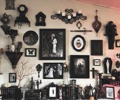 there are many pictures on the wall with black and white photos above them, including an old fashioned clock