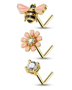 three different types of piercings with flowers and bees on them, one is pink