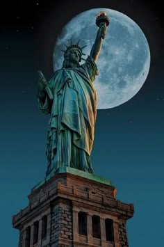 the statue of liberty is lit up at night with the moon in the sky behind it