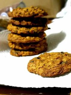 cookies are stacked on top of each other on a white napkin next to a knife