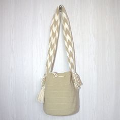 100% handwoven bag by Colombian women belonging to the Wayuu community. The elaboration of this product takes between 20 to 23 days, their sale is one of the main sources of support for their community. It is a completely comfortable, versatile, resistant bag; Its colors are striking and combine with any garment. Recommendations  It is suggested that when washing this type of backpack, the cords are inserted inside it and that it be placed inside a washing bag. It is not recommended to put it in the dryer, instead it can be hung to dry completely. specs Height: 10 In   /  27 cm Width:  09 In  /  25 cm Strap:   42 In  /  109 cm Made in:  La Guajira - Colombia Natural Woven Backpack, Handmade Natural Backpack For Everyday Use, Everyday Handmade Bucket Bag Backpack, Artisan Handwoven Bucket Bag For Everyday, Beige Crochet Backpack For Everyday Use, Handwoven Cream Rectangular Bucket Bag, Cream Handwoven Rectangular Bucket Bag, Everyday Beige Crochet Backpack, Cream Rectangular Handwoven Bucket Bag