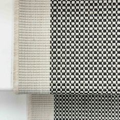 two black and white rugs sitting next to each other