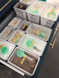 several plastic containers filled with food on top of a counter next to other containers and spoons