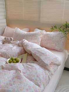 a bed with pillows and fruit on it