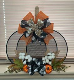 a wreath made out of fabric and pumpkins