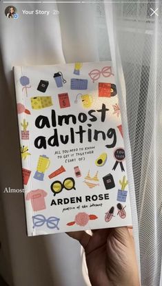 the book almost adulting is in someone's hand