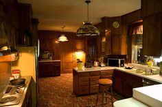 a kitchen with wooden cabinets and an island in front of a stove top oven next to a microwave