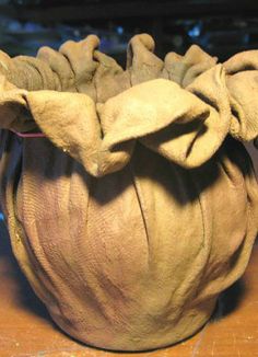 an elephant's head made out of clay sitting on a table