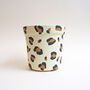 a paper cup with leopard print on it