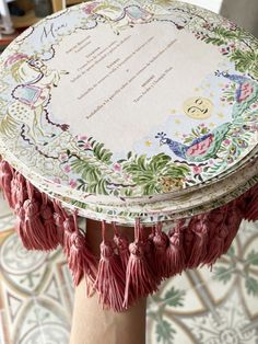 a round table with tassels on top of it