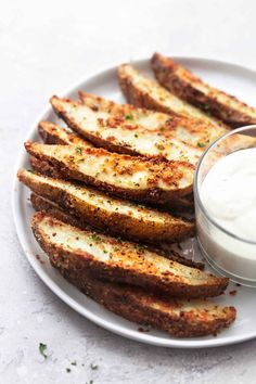 grilled eggplant fries on a white plate with ranch dip in the middle