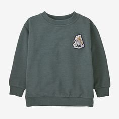 Cocoon babies in comfort with the supersoft Baby Lightweight Crew Sweatshirt. Made of cozy organic cotton/polyester knit fleece fabric, the casual crewneck sweatshirt has dropped-shoulder sleeves for easy movement and comfort. Rib knitting at cuffs and hem hold in warmth. Original artwork is screen-printed using inks that are PVC- and phthalate-free. Fair Trade Certified™ sewn. | Patagonia Baby Lightweight Crewneck Sweatshirt in Nouveau Green, 12-18 Months - Kids' Sweatshirts & Pullovers - Organ Toddler Boys Sweatshirt, Patagonia Baby, Rib Knitting, Baby Patagonia, Patagonia Outfit, Patagonia Kids, Boys Sweatshirts, Toddler Boy Outfits, Crew Sweatshirts