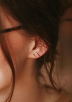 These simple studs are officially raising the BAR. Pair with your other favorite earring—we love combining these with anything from our MINI Collection, or wear these as the main act. A favorite, versatile, everyday stud. Bar measures 1mm x 10mm or 1mm x 6mm. Sold as a pair. Shown on Abbie with our Tiny Twist Earrings. Available in 14kt Gold Fill + Sterling Silver. Our jewelry is handmade so each piece will be unique and may vary slightly from what is pictured. Tiny Stud Earrings Minimalist, Simple Everyday Earrings, Poppy Ring, Simple Studs, Twist Earrings, Bolo Necklace, Horseshoe Earrings, Everyday Wear Jewelry, Earring Sets