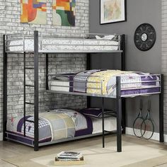 the bunk bed has two sets of mattresses on it and is in front of a brick wall