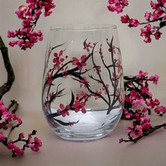 Hand painted cherry blossom wine glasses make a perfect gift, either alone or paired with a nice bottle of wine. Tuck inside a gift bag or create a simple gift basket for a finishing touch and you have the perfect gift for any occasion. Delicate black tree limbs with elegant tiny pink flowers and red centers around the glass. Keep for yourself and enjoy a glass of pinot on a summer evening. ITEM DETAILS: 🤍The price listed is for one glass…order just one glass for yourself or more for a friend! Painting Glass Cups, Small Glass Bottle Crafts, Wine Cup Painting Ideas, Simple Gift Basket, Wine Glass Painting Ideas Easy, Glass Cup Painting, Painted Stemless Wine Glasses, Glass Bottle Painting, Wine Glass Painting