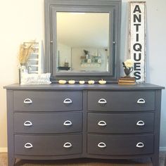 a dresser with a mirror on top of it