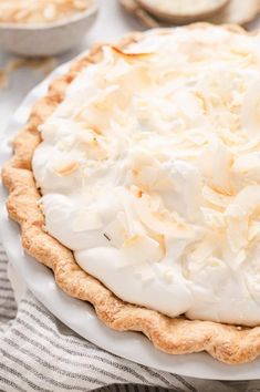 a pie topped with whipped cream on top of a white plate