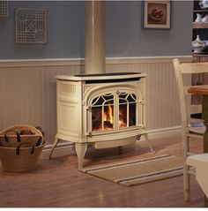 a white stove sitting inside of a living room next to a basket on the floor