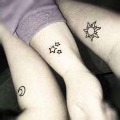 two people with matching tattoos on their arms, both have sun and moon tattoo designs