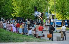 a group of people standing around each other