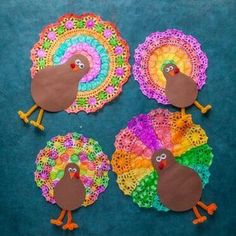 paper plate turkeys made with crochet doily on a blue tablecloth