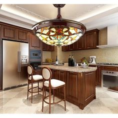 a large kitchen with wooden cabinets and marble counter tops, along with two bar stools