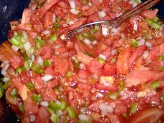 the food is being prepared and ready to be cooked in the pot with tongs