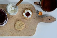 there are jams and cookies on the cutting board