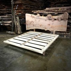 a bed frame made out of wood in a warehouse