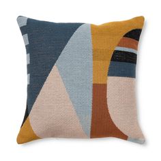 a multicolored pillow with an abstract design on the front and back, sitting on a white surface