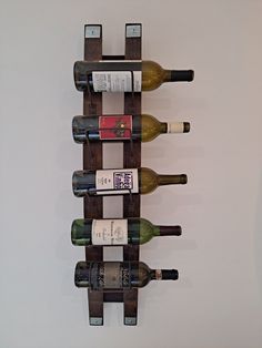 a wooden wine rack with six bottles on it's sides and four empty ones in the middle