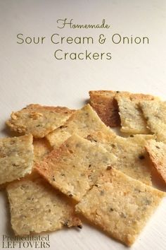 homemade sour cream and onion crackers on a white plate with text overlay that reads homemade sour cream and onion crackers