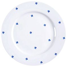 an empty white plate with blue flowers on the rim and bottom, against a white background