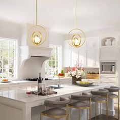 a kitchen with white cabinets and counter tops has stools in front of the island