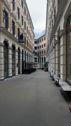 an empty city street lined with tall buildings