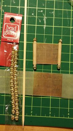 two pieces of wood sitting on top of a cutting board next to a pair of scissors