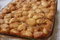 a casserole dish is covered with cinnamon rolls and sugared crumbs