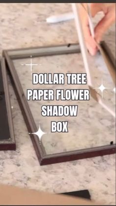 the dollar tree paper flower shadow box is open and ready to be put into it