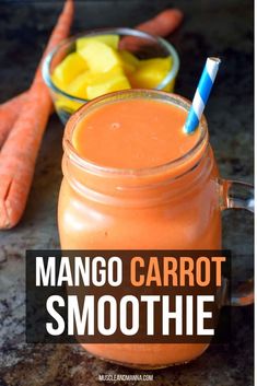 mango carrot smoothie in a mason jar with a blue and white striped straw next to it