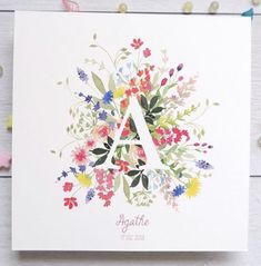 a floral monogrammed card with the letter a in it's center surrounded by flowers