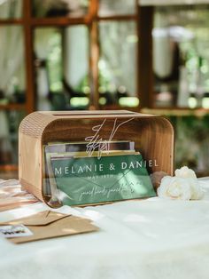 a table topped with a wooden box filled with cards